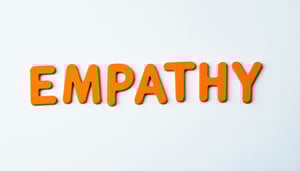 The image shows the word EMPATHY written in light orange letters in the center of a white coloured background or material i wont the font to look young and be in line with education theme-1