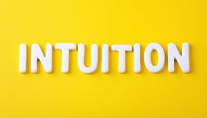 The image shows the word INTUITION written in white letters in the center of a light yellow coloured background or material i wont the font to look young and be in line with education theme-1