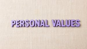 The image shows the word PERSONAL VALUES written in light purple letters in the center of a creamneutral fabric material